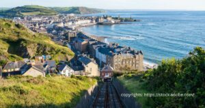 The scenic beauty of Aberystwyth, showcasing its historic buildings and cliff railway, a jewel in Wales' medieval crown.