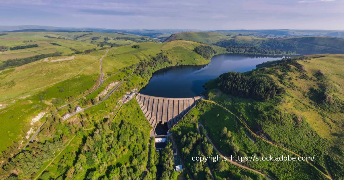 Aerial view of Clywedog Reservoir, the highest dam in Wales, surrounded by lush landscape.