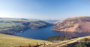 Scenic view of Clywedog Reservoir amidst the rolling hills of Powys"Description: "A serene landscape frames Clywedog Reservoir, illustrating its harmonious presence in the Welsh countryside.