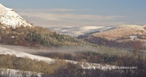 Snow-dusted hills and misty forests near Cardiff, showcasing Wales' stunning winter scenery.