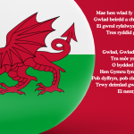 The Welsh flag featuring a red dragon on a white and green background, with the lyrics of the Welsh national anthem "Hen Wlad Fy Nhadau" written in white on the right side.