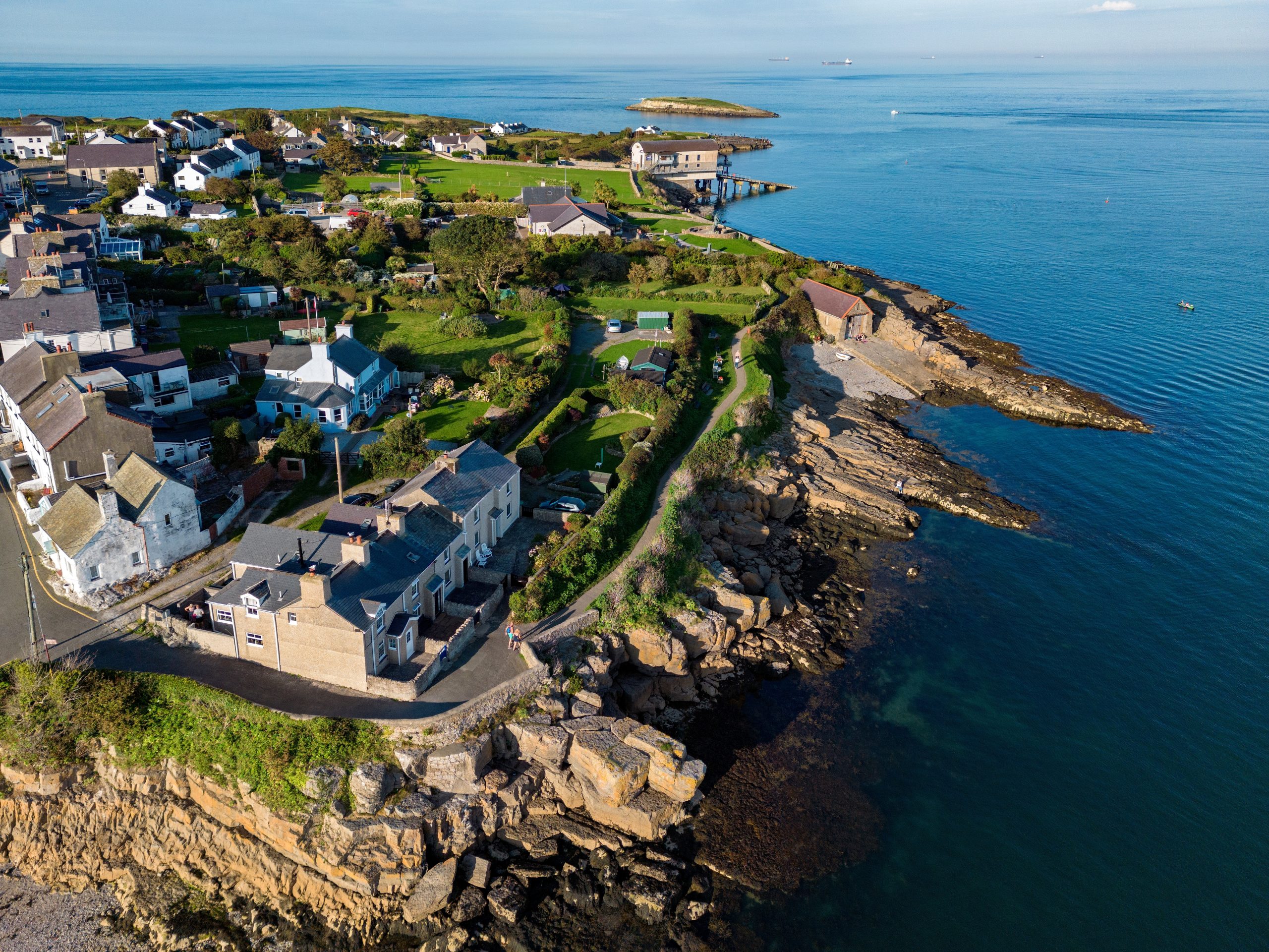 Aerial view of Bull Bay Village near Amlwch on the island of Anglesey, North Wales, with coastal houses and rocky shoreline.