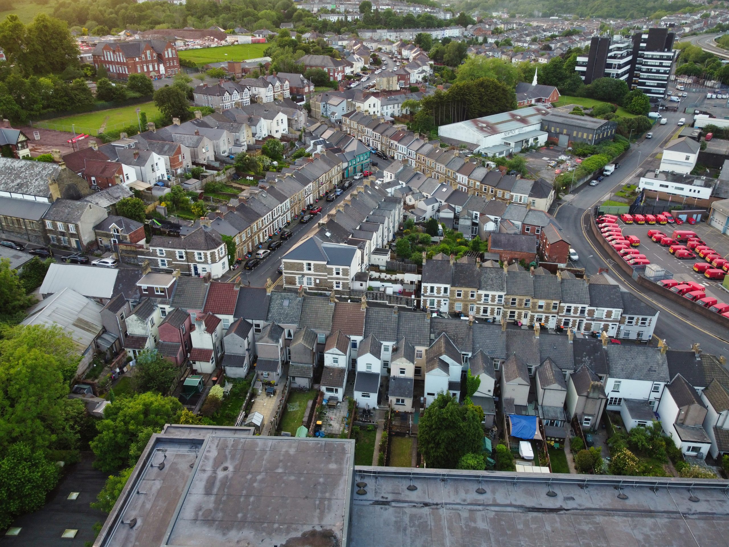 Aerial view of Newport, Wales, showing residential streets, rooftops, and surrounding city infrastructure near the River Usk.