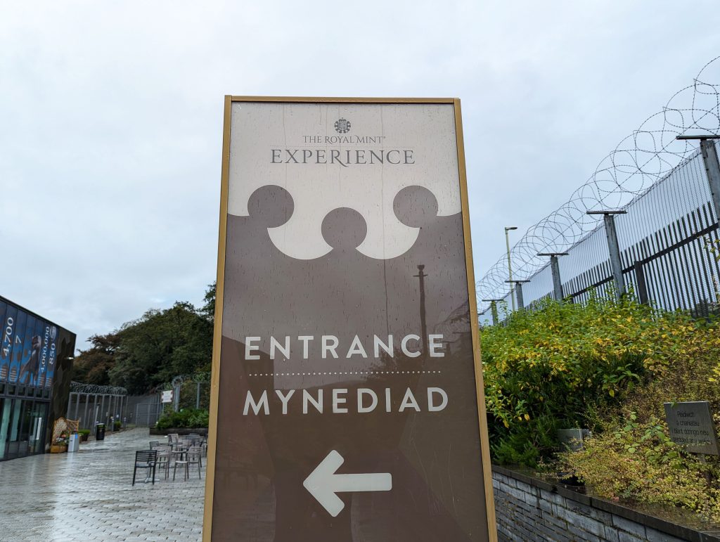 Bilingual sign at the entrance of the Royal Mint Experience in Llantrisant, South Wales