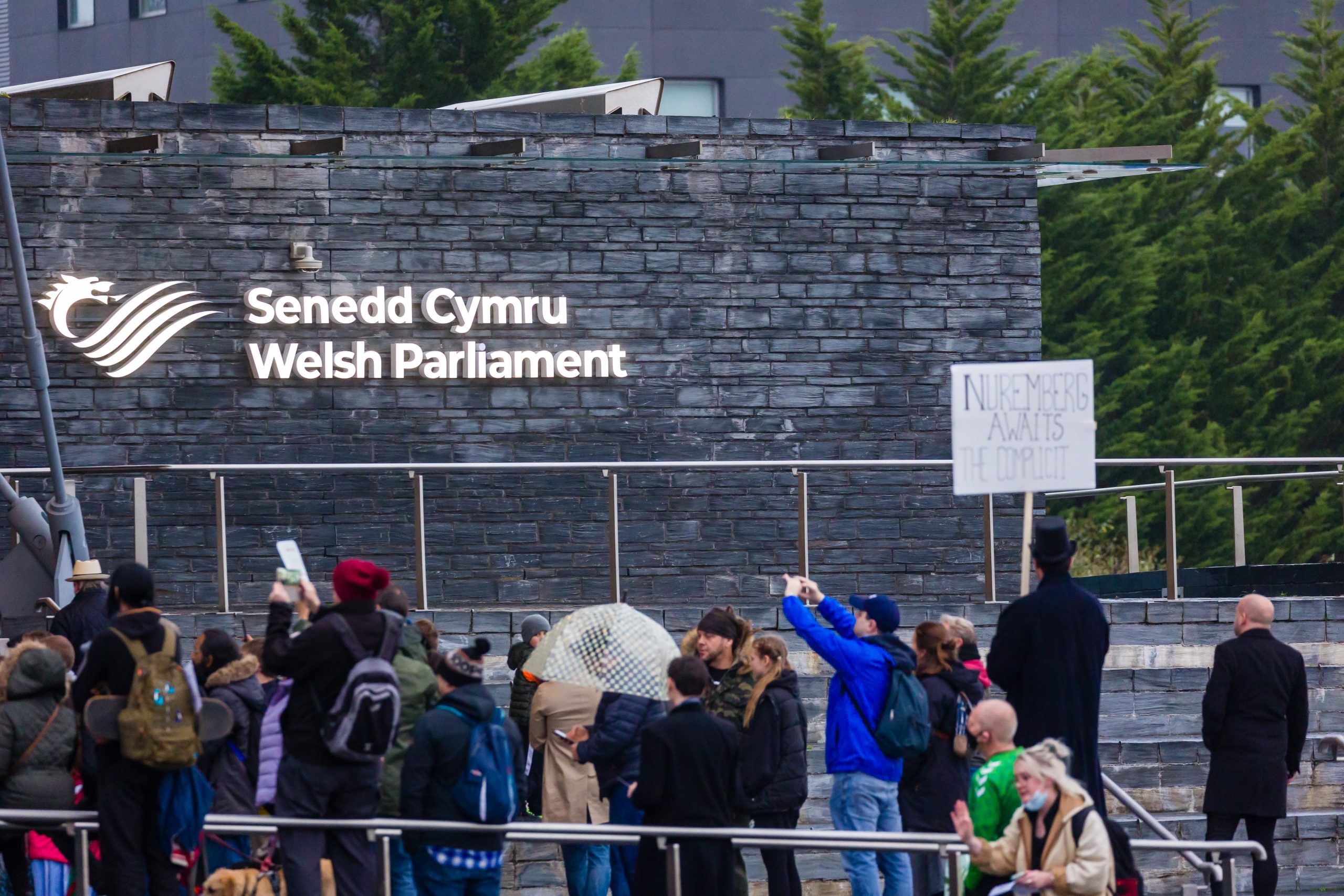 People gathered outside the Senedd Cymru Welsh Parliament building in Cardiff, Wales.