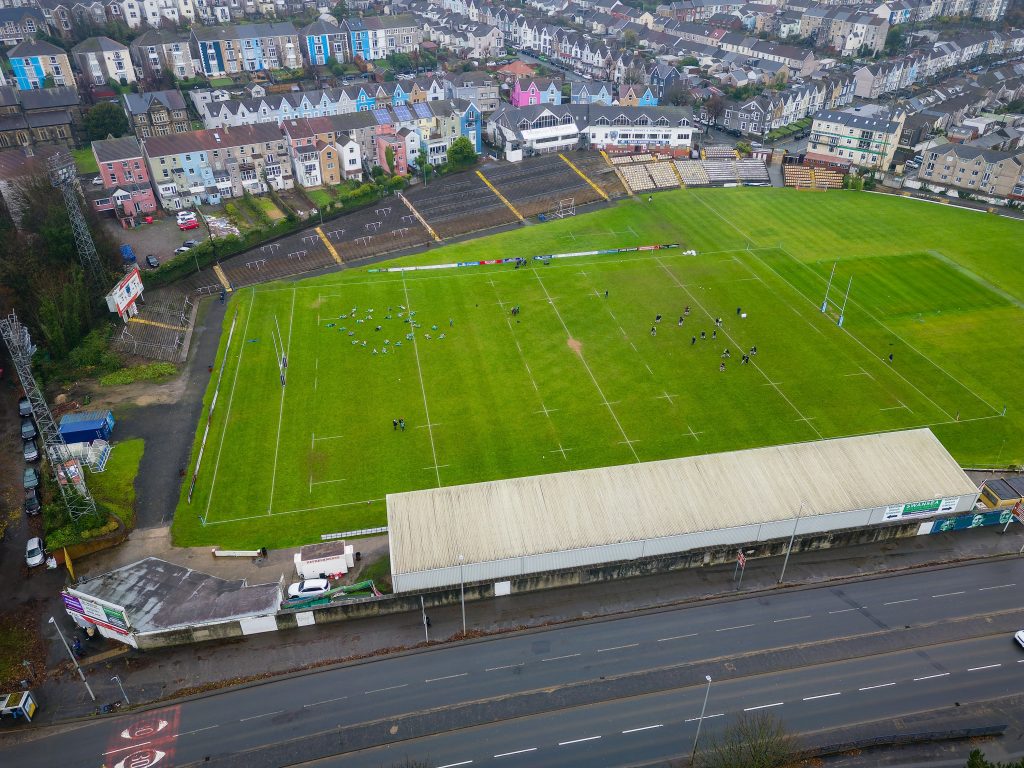 Aerial view of St Helen’s rugby and cricket ground in Swansea, Wales, with surrounding colourful residential housing.
