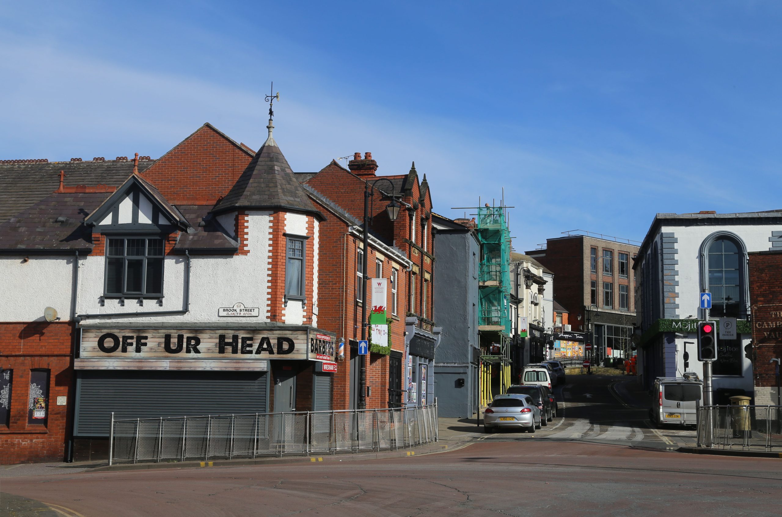 Intersection near Wrexham city centre, showing local shops and traditional Welsh architecture in North Wales.